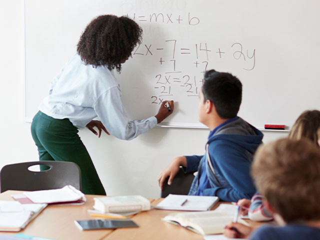 Female teacher giving math lesson